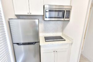 Compact kitchen at this Fort Walton Beach hotel with mini fridge, microwave, and cooktop.